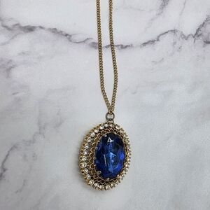 Elegant Gold-Tone Pendant Necklace with Deep Blue Oval Crystal